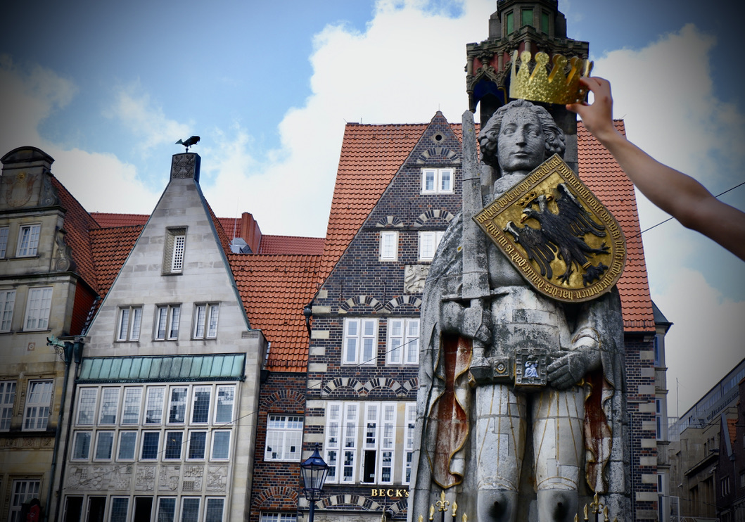 Der Bremer Roland bekommt eine goldene Krone aufgesetzt.