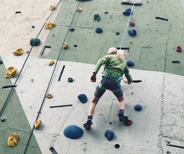 Schoolchild on a climbing wall
