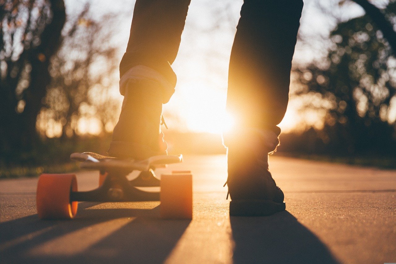 Child on a skateboard at sunset